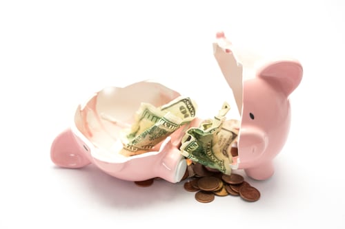 Piggy bank broken with money inside on white background